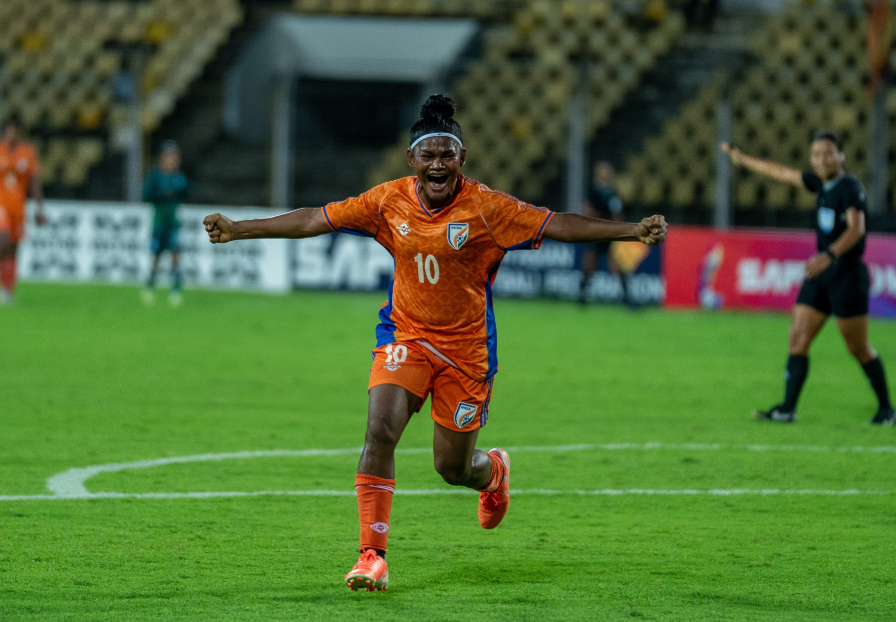 Indian women’s football player celebrates on the pitch as the Blue Tigresses continue their rise after qualifying for the AFC Women’s Asian Cup.