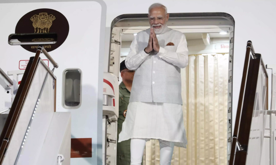 Prime Minister Narendra Modi arrives in Kyrgyzstan for the 26th Shanghai Cooperation Organisation Summit and greets officials with a namaste after stepping from his aircraft. Caption